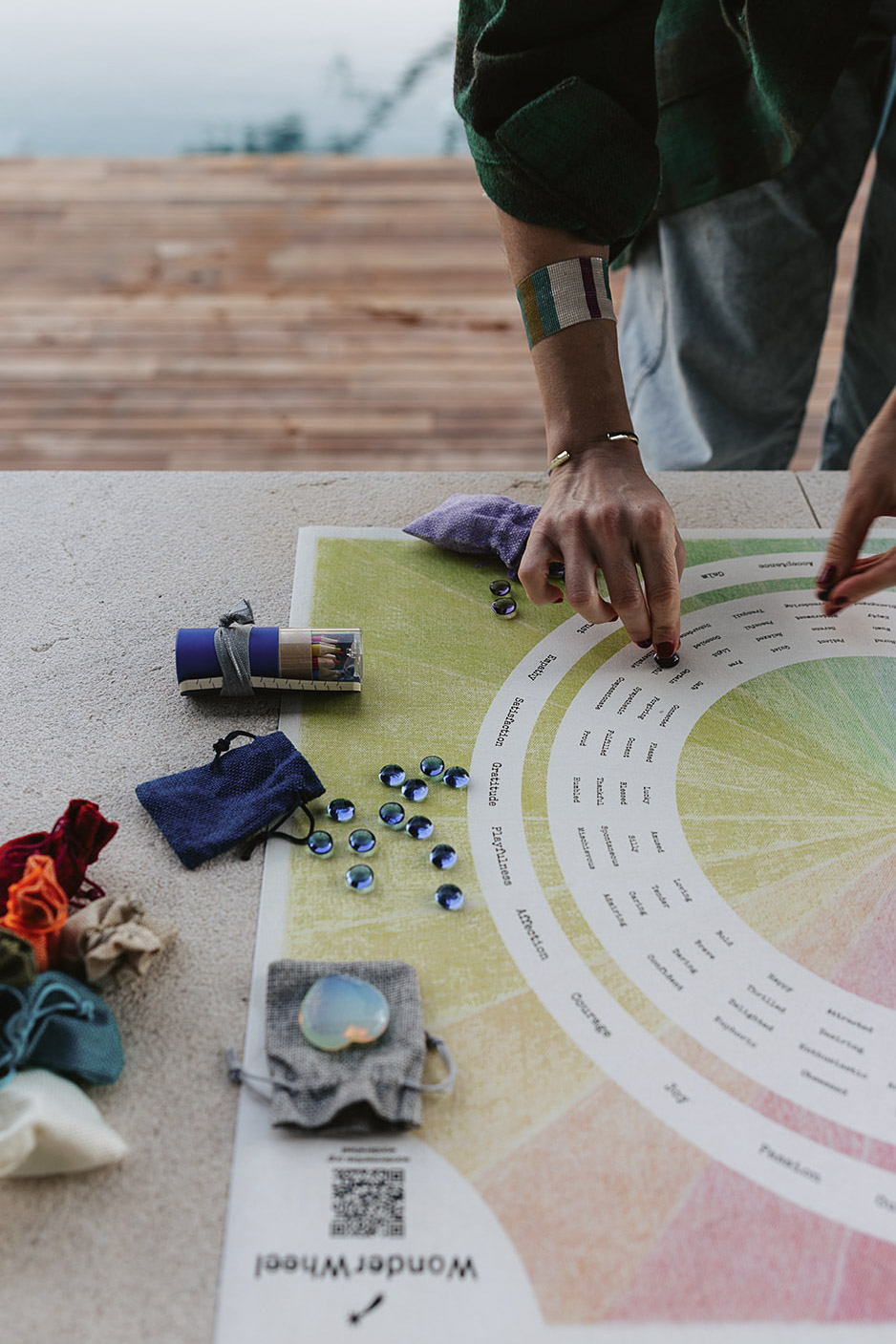 A practitioner placing a glass marker on the WonderWheel canvas during a session.